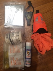Emergency blanket, whistle, packable towel from Camp's Corner Singapore, sunscreen stick, and my first-aid kit