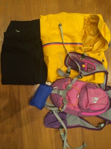 Yellow OMM Aeon Jacket, Nathan's Intensity Pack, packed blue Patagonia Houdini jacket, and Haglof waterproof pants